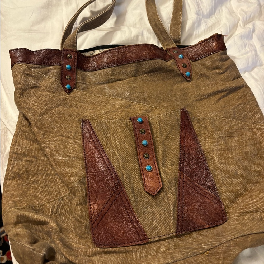 Gently used Mona B bag. Oil/wax canvas with leather/turquoise accents.